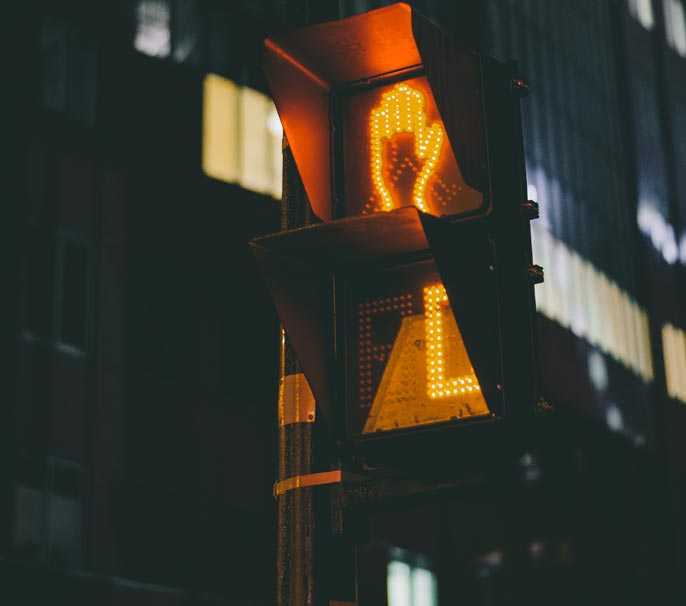 pedestrian traffic signal showing do not walk symbols