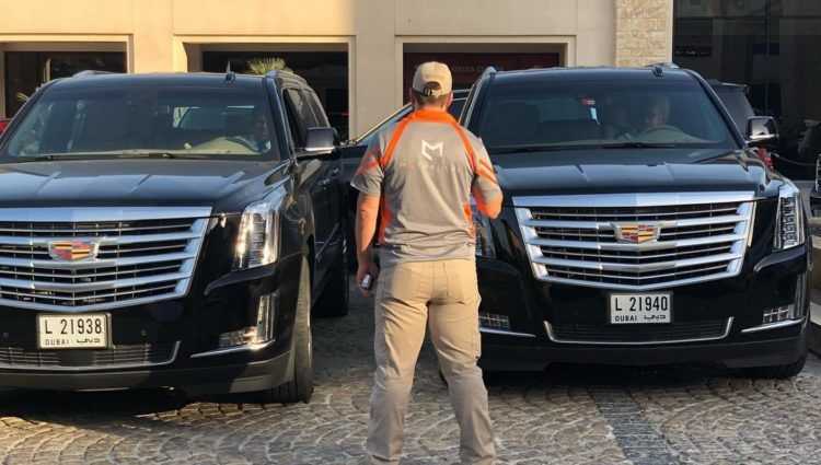 motus one consultant with two cadillac escalades