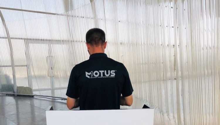 motus one personnel standing at a kiosk